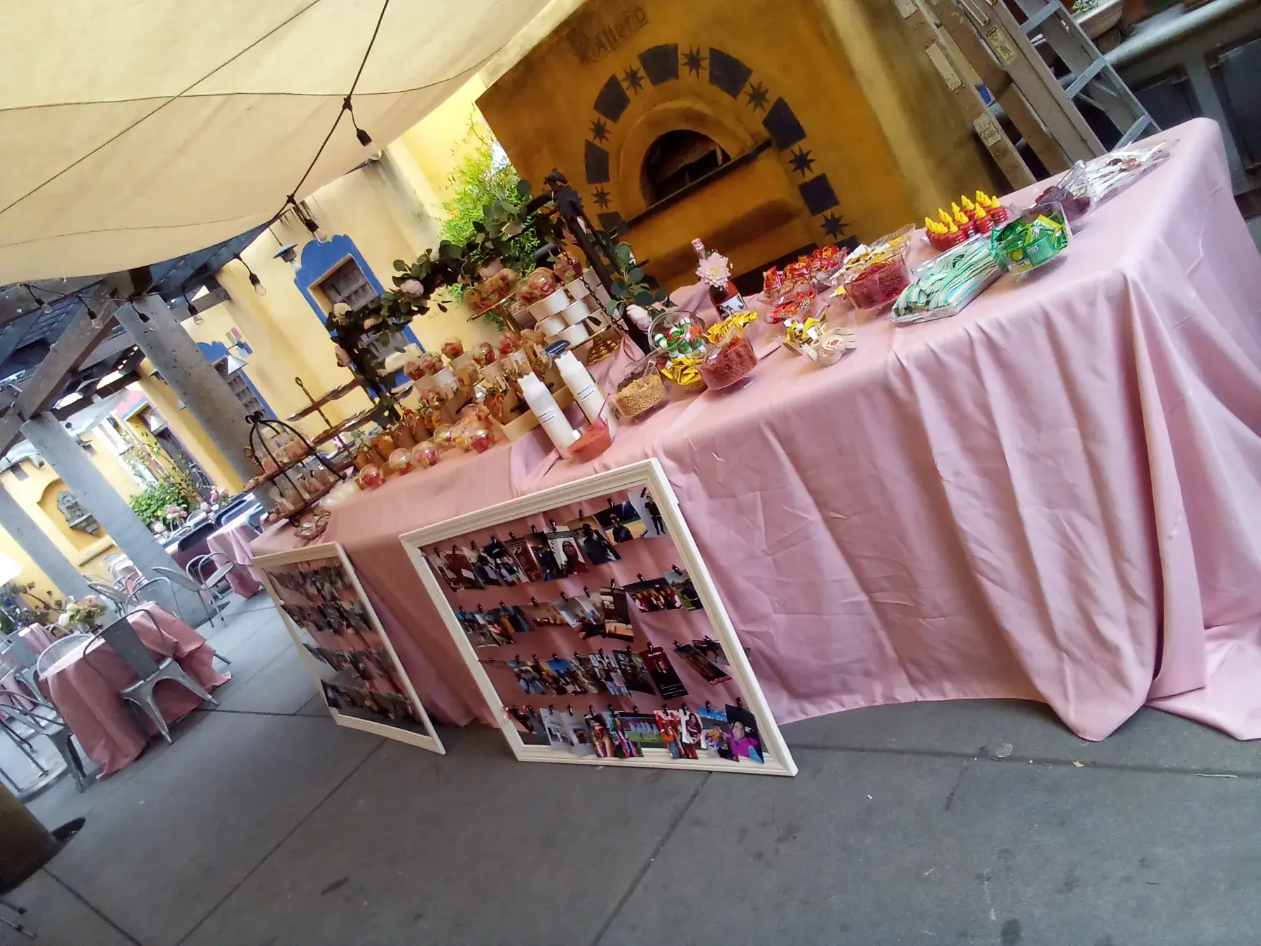 A candy and dessert table set beside the restaurant fireplace.