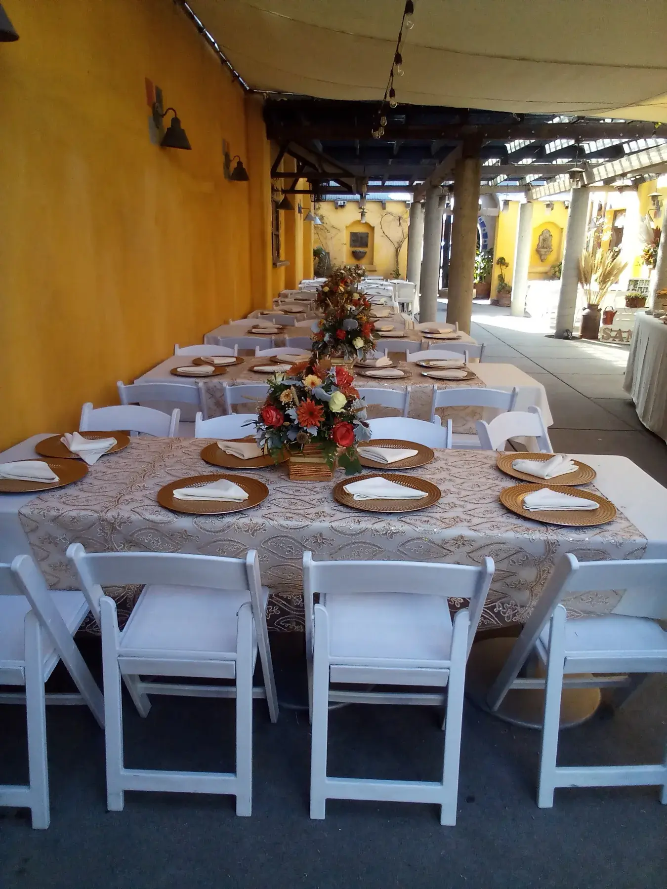 Long dining tables styled with soft pink runners and floral details.